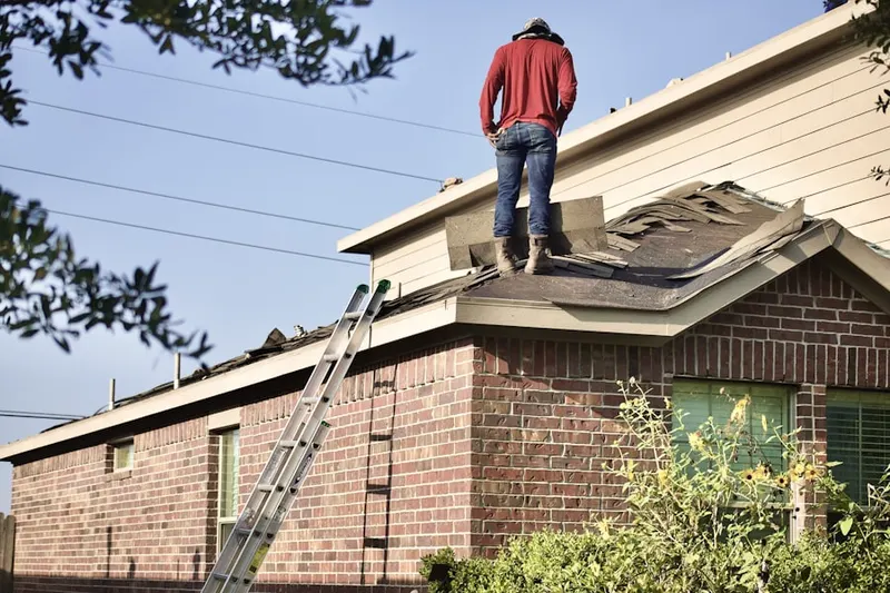 Professional roofer working on a residential roof in Cheesequake